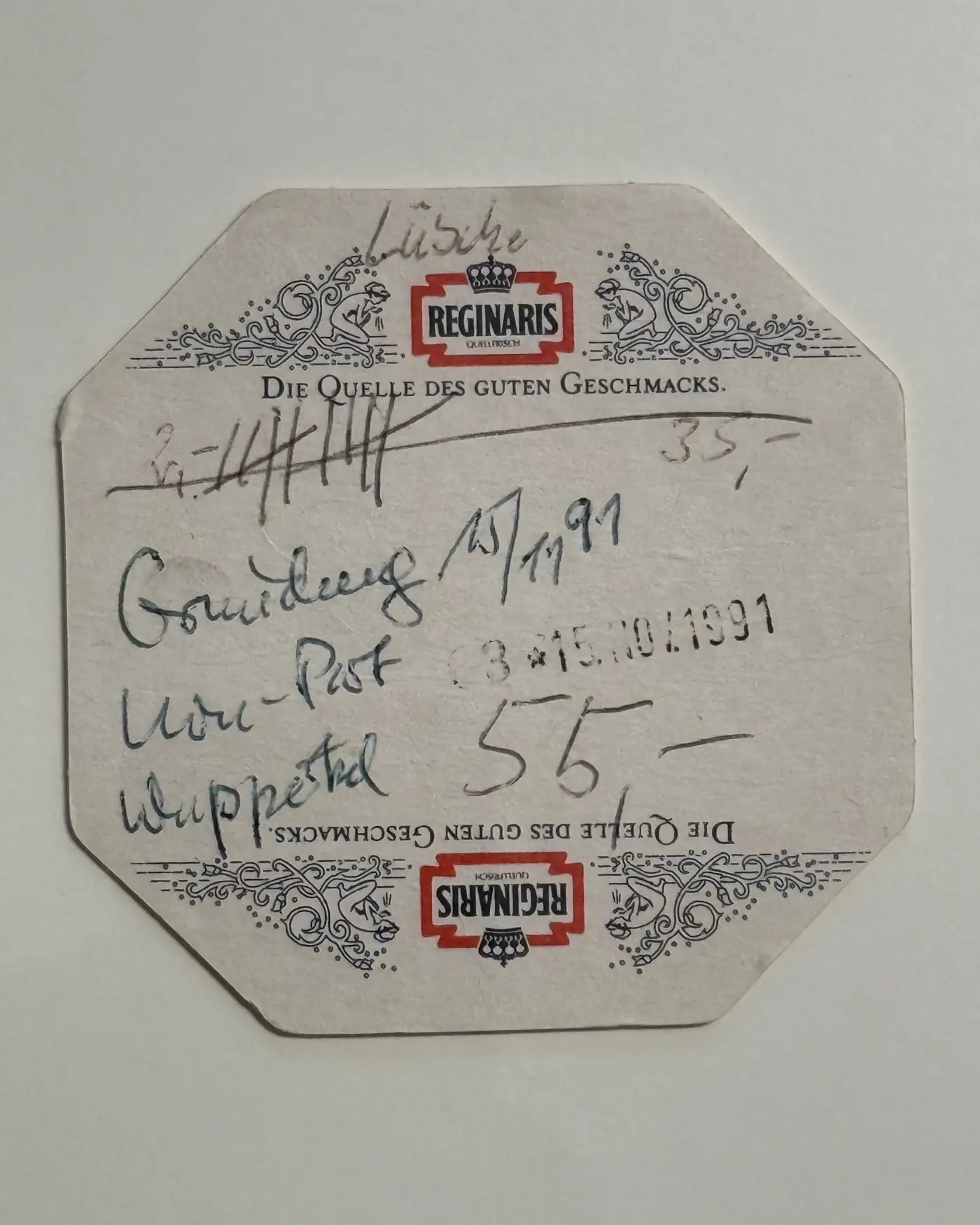 Bierdeckel mit handschriftlicher Notiz und Poststempel vom 15. November 1991