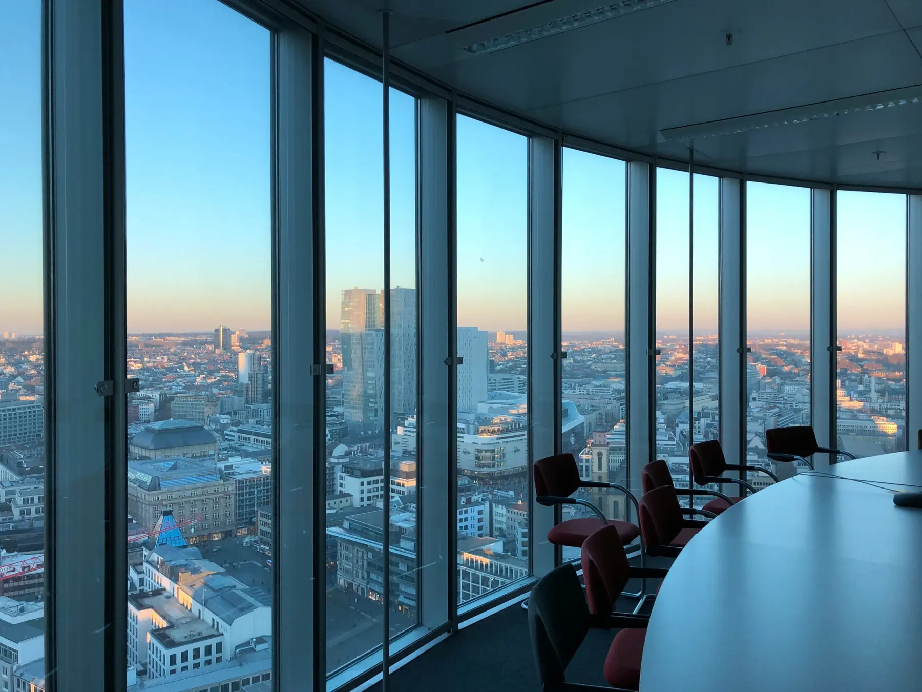 An empty meeting room with a view over the city